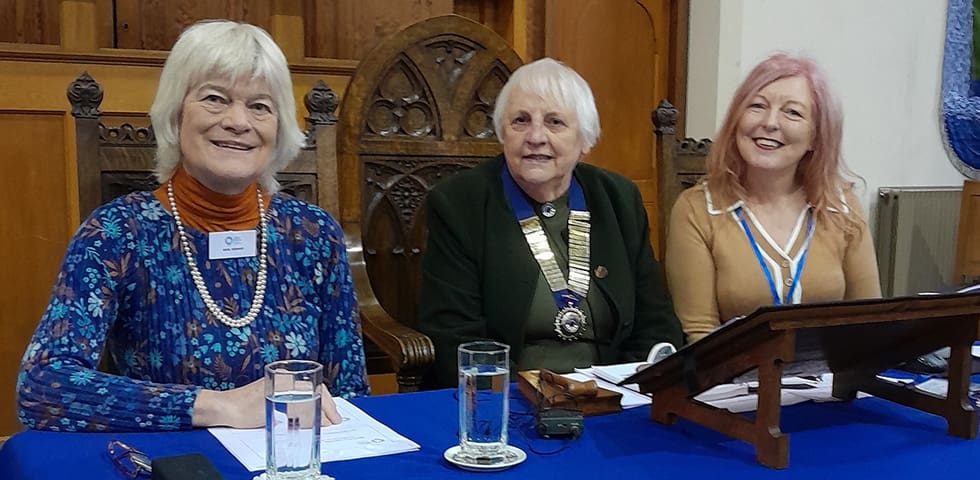 Three women sat behind a table. Gail Bishop, Elsie Leadley and Ruth Batty