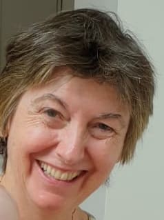 Head shot of a white woman smiling at the camera