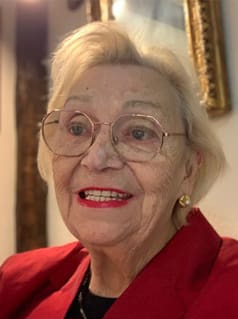 Head shot of an older white woman with red lipstick