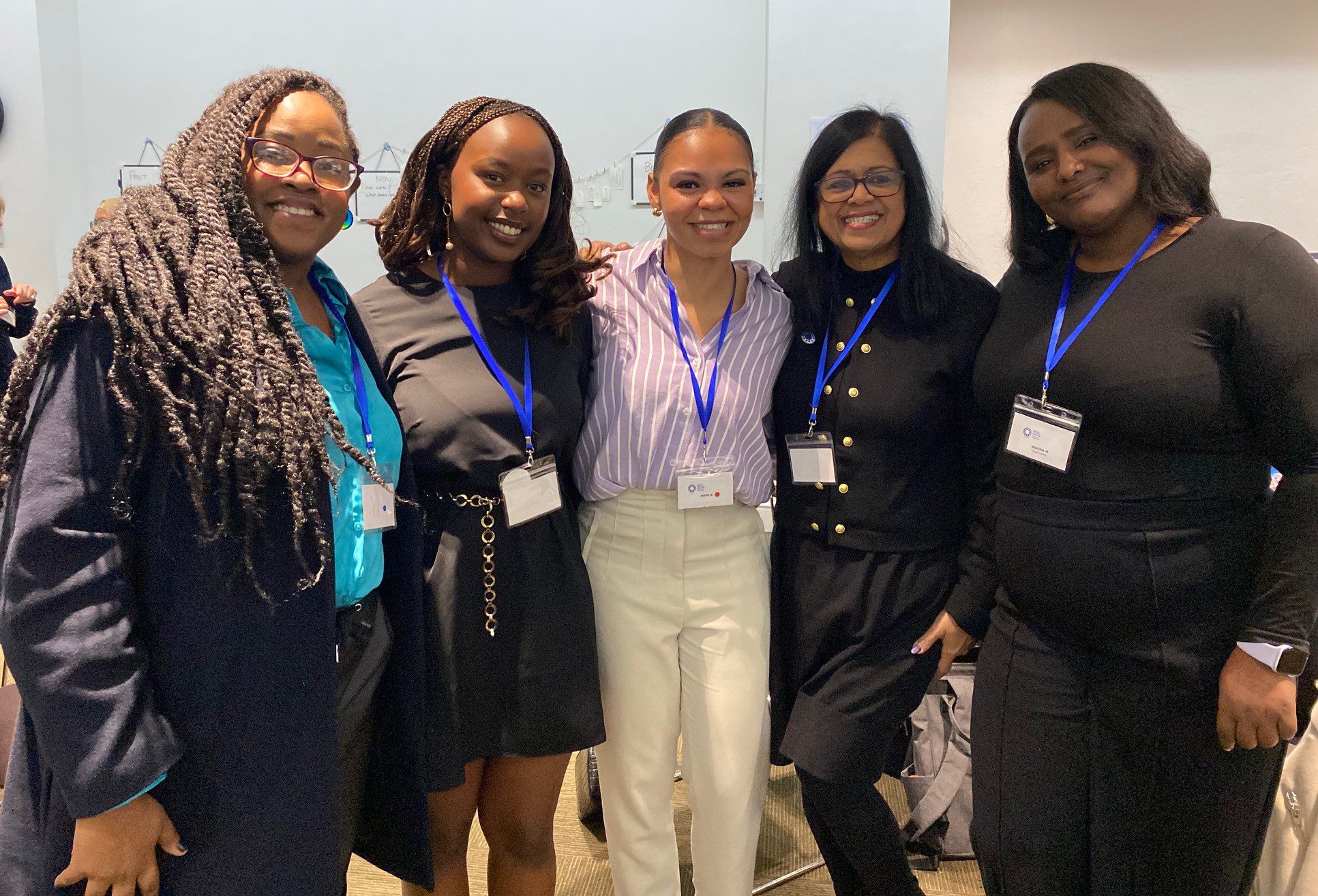 lady in red jacket addressing an audiencen